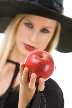 Image of witch giving red ripe apple to somebody