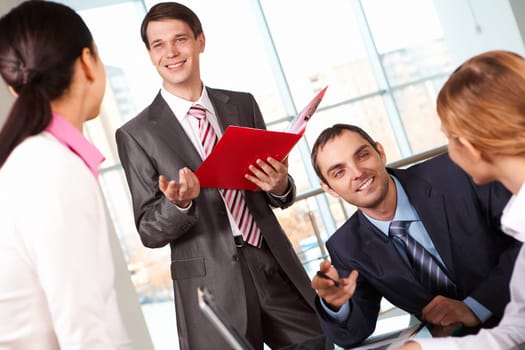 Image of businessmen answering questions of colleagues at meeting