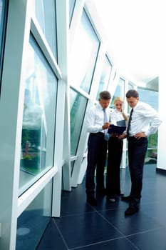 Three smart employees discussing plan at meeting