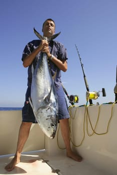 Angler fihing big game bluefin tuna on Mediterranean saltwater