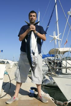 Angler fishing big game Albacore tuna on Mediterranean saltwater