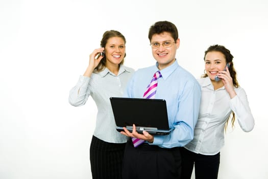 Portrait of confident man with two business women near by calling by phones