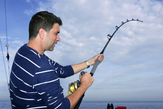 Angler fisherman fighting big fish rod and reel saltwater ocean