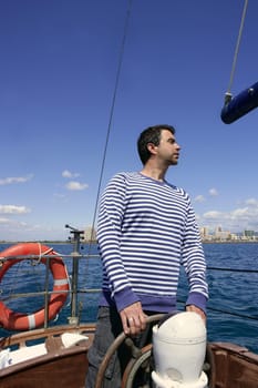 blue sailor man sailing vintage wooden sailboat mediterranean sea
