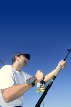 Angler fisherman trolling rod and reel fighting saltwater fish