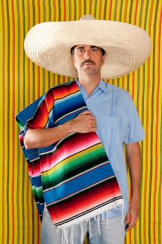 Mexican mustache man portrait with sombrero holding serape in shoulder