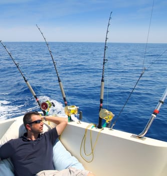 Sailor man fishing resting in boat summer vacation blue sea