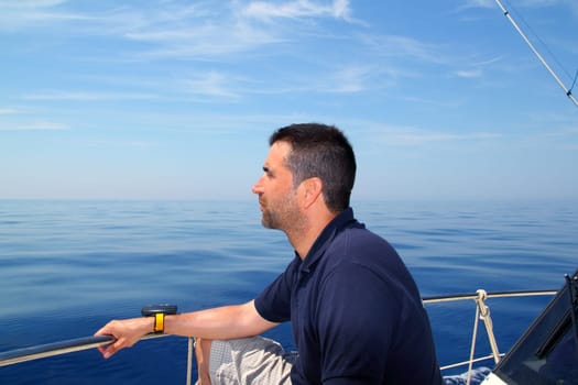 Sailor man sailing boat blue calm ocean water Mediterranean sea