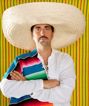 Mexican mustache man portrait with sombrero holding serape in shoulder