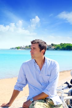 beach vacation man looking the sea blue shirt bicycle