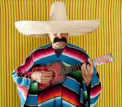 Mexican man serape poncho sombrero playing guitar typical Mexico