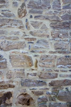 Old wall with irregular pattern of stone - background.
