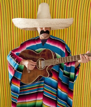 Mexican man serape poncho sombrero playing guitar typical Mexico