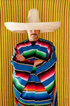 Mexican typical poncho man with sombrero and mustache over yellow background