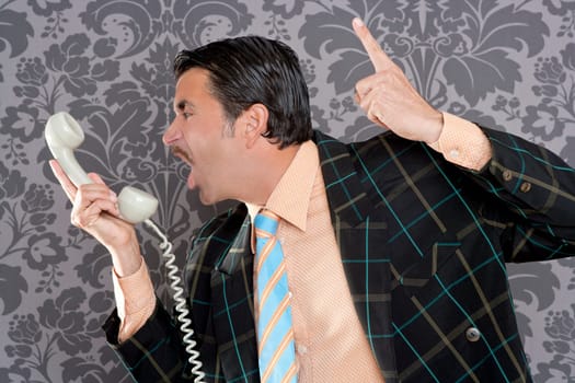 businessman shouting angry expression talking by  telephone with retro mustache