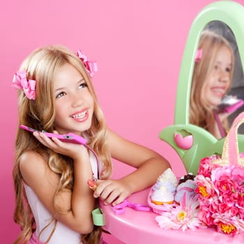 blond fashion doll girl talking with mobile phone in pink vanity
