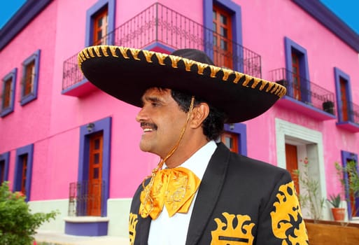Charro mexican Mariachi portrait in pink Mexico house