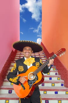 Charro Mariachi singer playing guitar in Mexico stairway