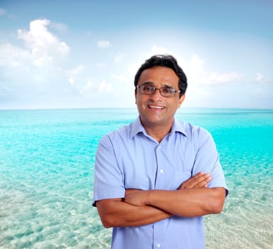 Indian latin tourist man spending his vacation in a perfect turquoise beach