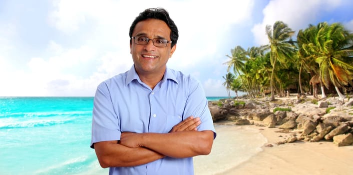 Indian man tourist portrait in tropical caribbean beach with palm trees