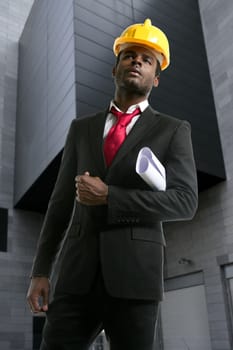 African american architect engineer with yellow hardhat and plans