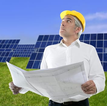 expertise architect senior engineer plan in hands solar plates meadow