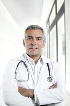 gray hair expertise handsome senior doctor hospital portrait white corridor