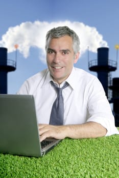 senior businessman working green grass desk computer smog indutrial smoke pollution