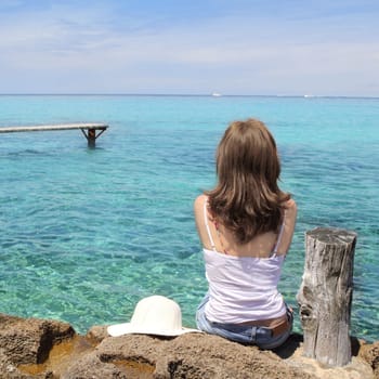 Tourist back woman looking Formentera turquoise sea Illetes Balearic islands
