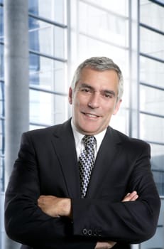 senior expertise gray hair businessman posing interior white modern office