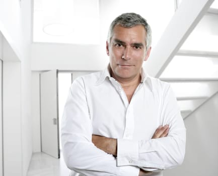 senior expertise gray hair businessman posing interior white modern office