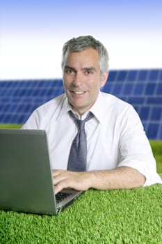senior businessman working green grass desk solar plates