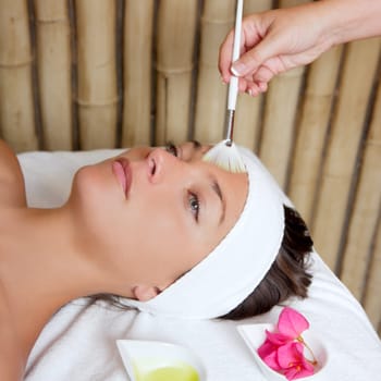 spa beauty facial treatment oil brush and bouganvillea flowers