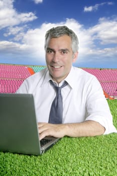 senior businessman working green grass in sport course