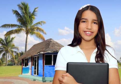 brunette teen  indian latin student holding laptop in jungle house tropical hut
