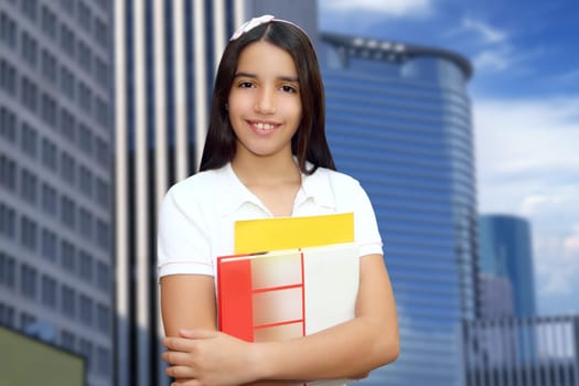 Brunette student young girl teen latin holding books modern city buildings