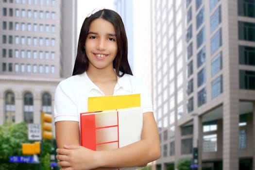 Brunette student young girl teen latin holding books modern city buildings