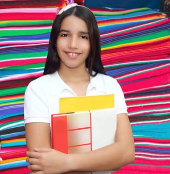 Brunette student young girl teen latin holding books serape mayan background
