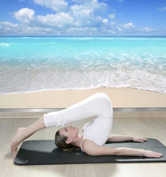 beautiful woman in black mat yoga in front a window view of tropical beach