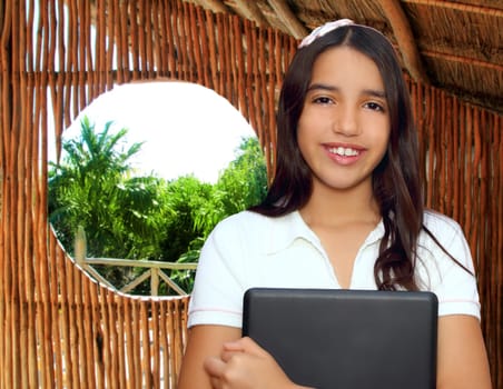 brunette teen  indian latin student holding laptop in jungle hut house