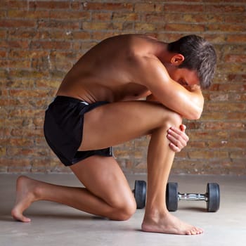 muscle shaped man on knee thinking with thinker posture