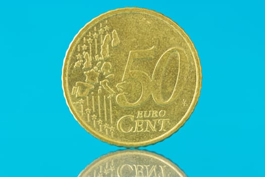Fifty euro cent with reflection on blue background