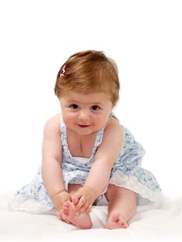 Happy baby sitting on white towel