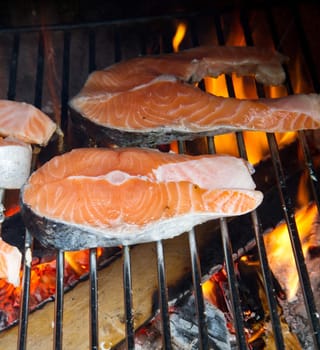 a fresh steak of salmon on grilled with flames