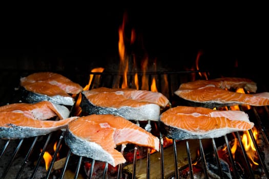 a fresh steak of salmon on grilled with flames