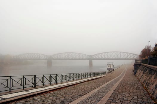 Prague railway bridge in early morning fog