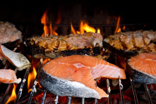a fresh steak of salmon on grilled with flames