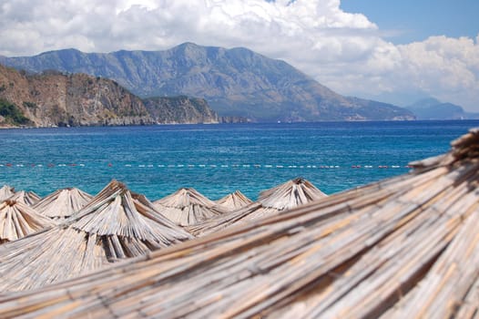 Straw umbrellas on Montenegrin beach