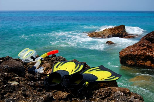 Snorkeling set on a rocky beach