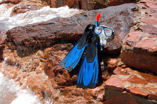 Snorkeling set on a rocky beach
